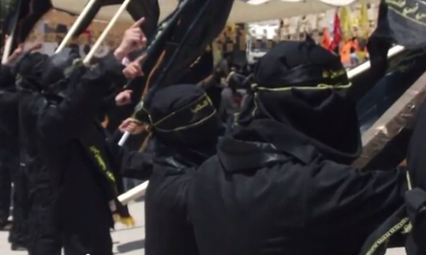 Raising a hand in the Islamic Jihad demonstration at al-Quds University (screenshot: YouTube)