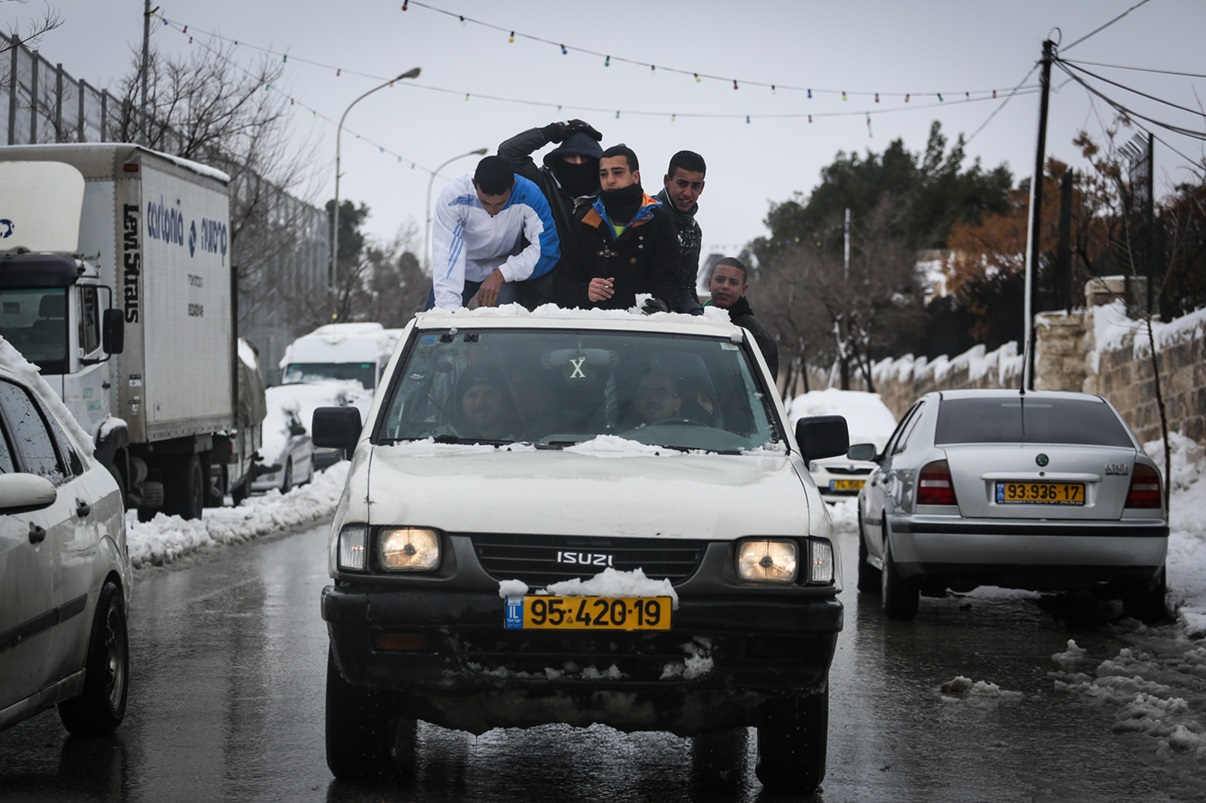 ילדים פלסטינים על אוטו בשלג, הר הזיתים. צילום: פלאש 90