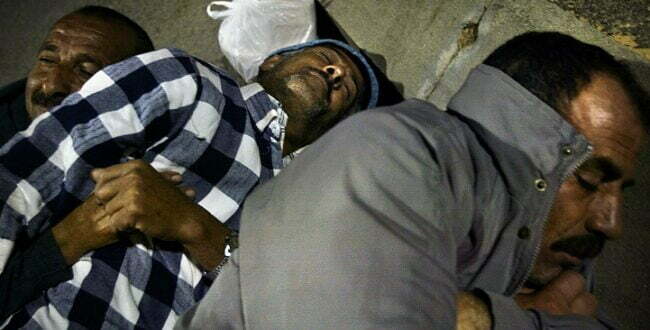 PALESTINIAN WORKERS SLEEP AFTER CROSSING EREZ BORDER.