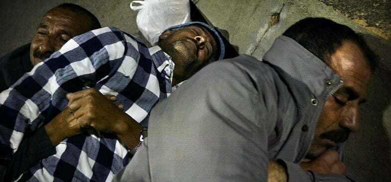 PALESTINIAN WORKERS SLEEP AFTER CROSSING EREZ BORDER.